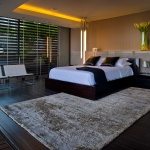 luxury-modern-bedroom-design-with-wooden-floor-tiles-white-bench-seat-carpet-tiles-and-wood-bed-frame-with-white-cover-ideas