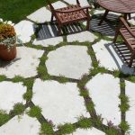 closeup-of-exploded-flagstone-patio-with-flowering-sedum